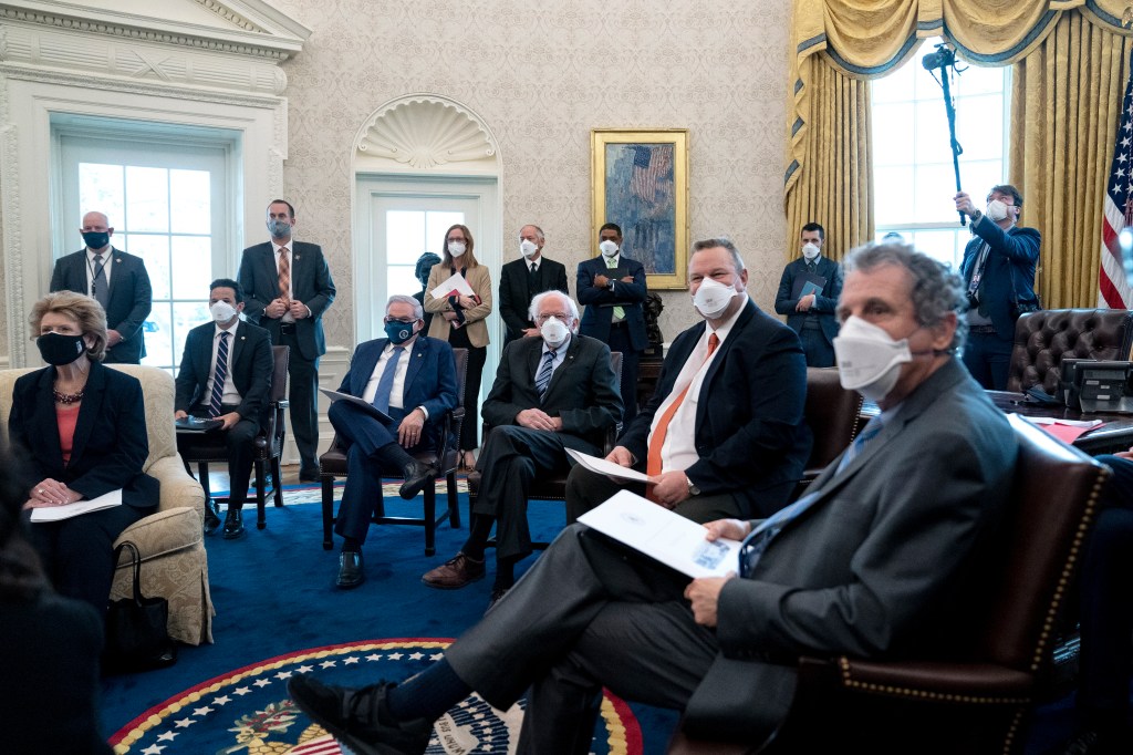 Brown in the Oval Office with other senators for a meeting with Biden on Feb. 3, 2021.