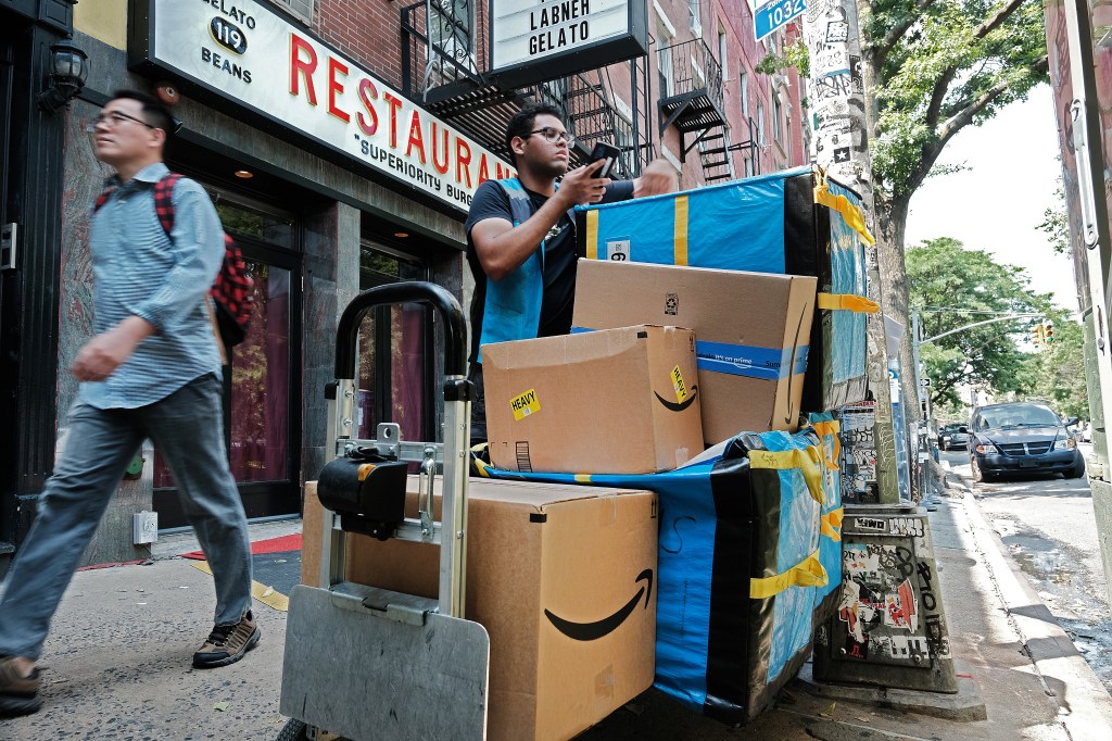 Amazon worker moving boxes during Amazon Prime Day in the East Village, New York City, July 2023