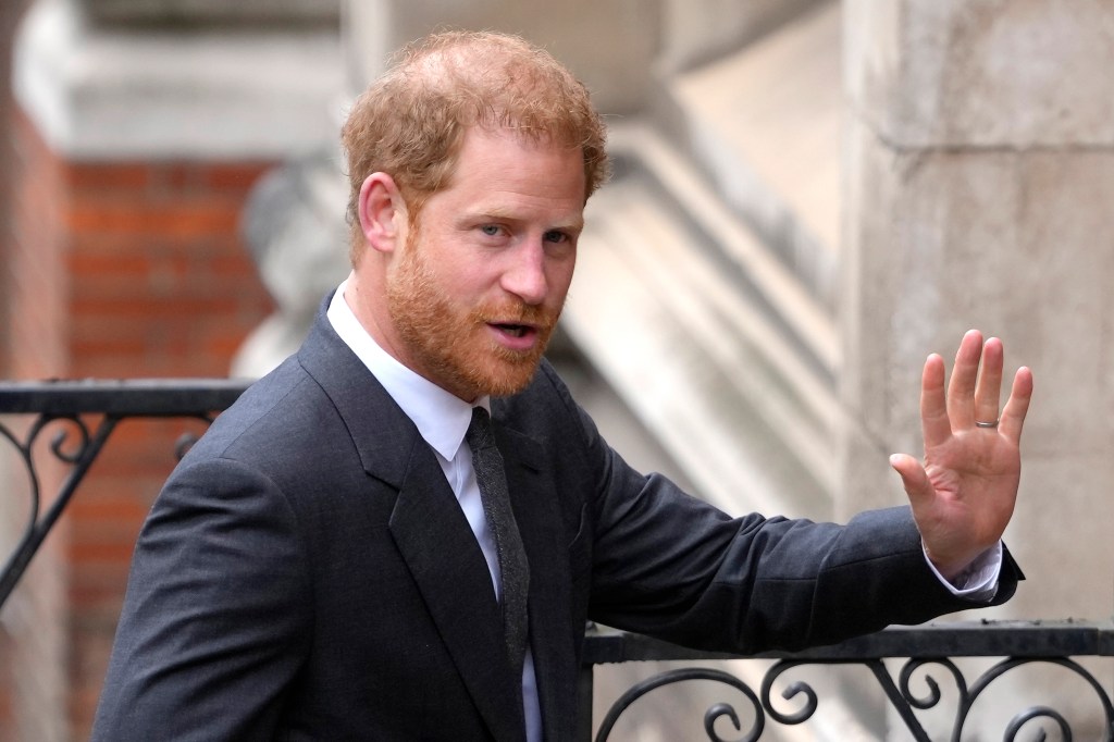 Prince Harry waves at members of the media as he arrives at the Royal Courts of Justice in London, on March 30, 2023. 