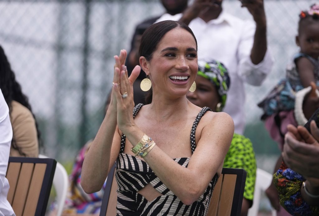 Meghan Markle clapping while watching Prince Harry play sitting volleyball at the Invictus Games in Abuja, Nigeria