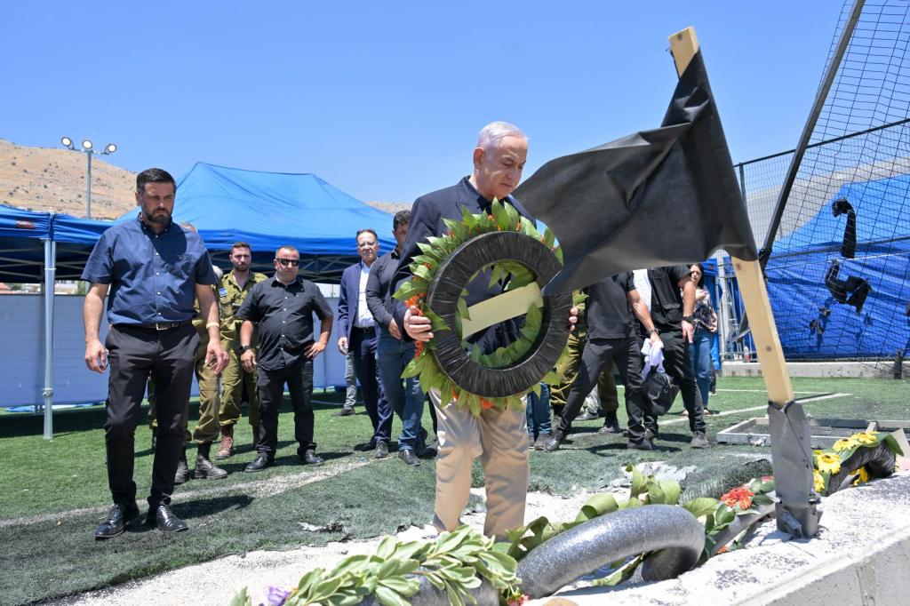 Israel's Prime Minister Benjamin Netanyahu vowed a "harsh" response against Hezbollah while visiting the graves of the 12 youths killed on Saturday.