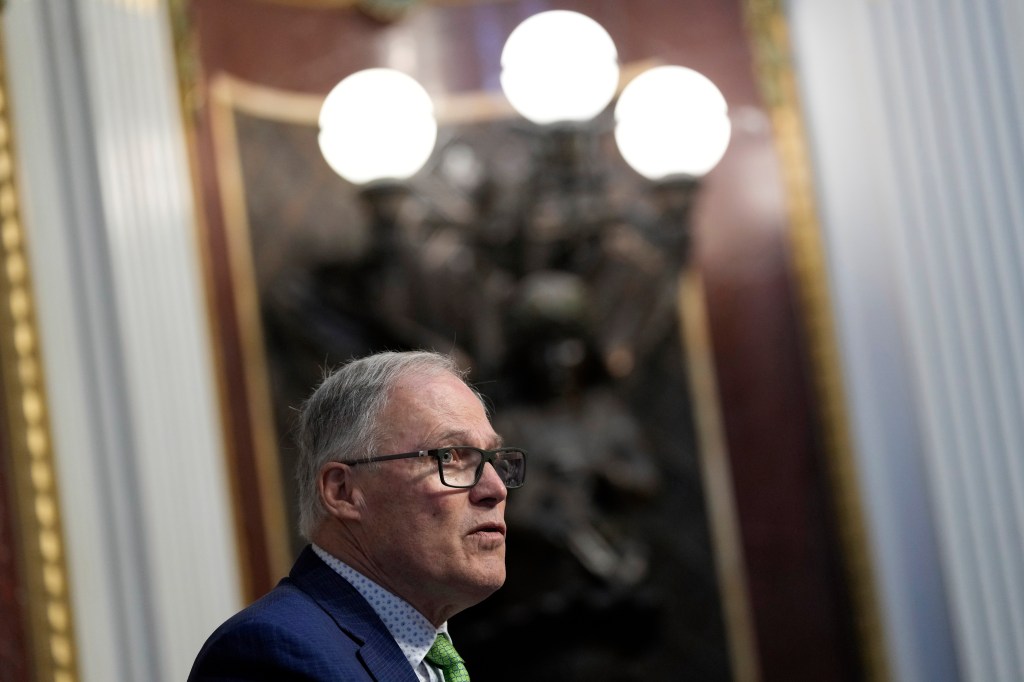 Washington Governor, Jay Inslee, delivering a speech during a signing ceremony, discussing the state's progress in fighting against climate change