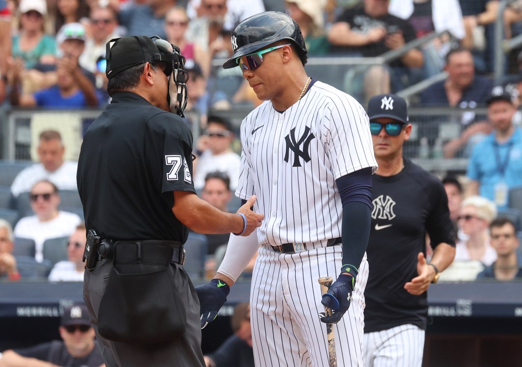 New York Yankees outfielder Juan Soto (22) appears to get a time violation resulting in a strikes out looking call by home plate umpire Alfonso Marquez (72) when the New York Yankees played the Cincinnati Reds Saturday, July 6, 2024 at Yankee Stadium 