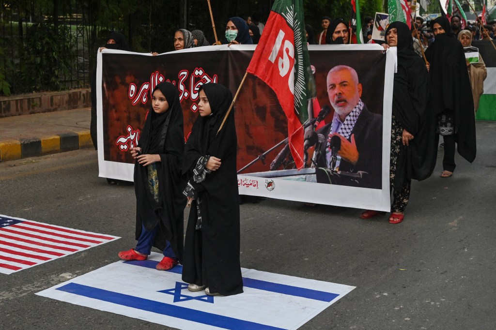 Activists and supporters of Imamiya Student Organization (ISO) hold Palestinian flags as they take part in a protest in Lahore on July 31, 2024, against the assassination of Hamas chief Ismail Haniyeh in an air strike.