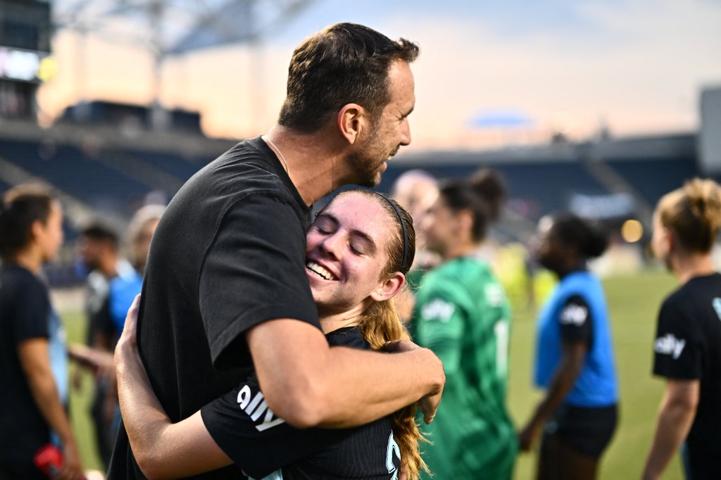 Gotham FC forward McKenna Whitham (31) hugs head coach Juan Carlos Amoros after the game against the Washington Spirit on July 28, 2024.