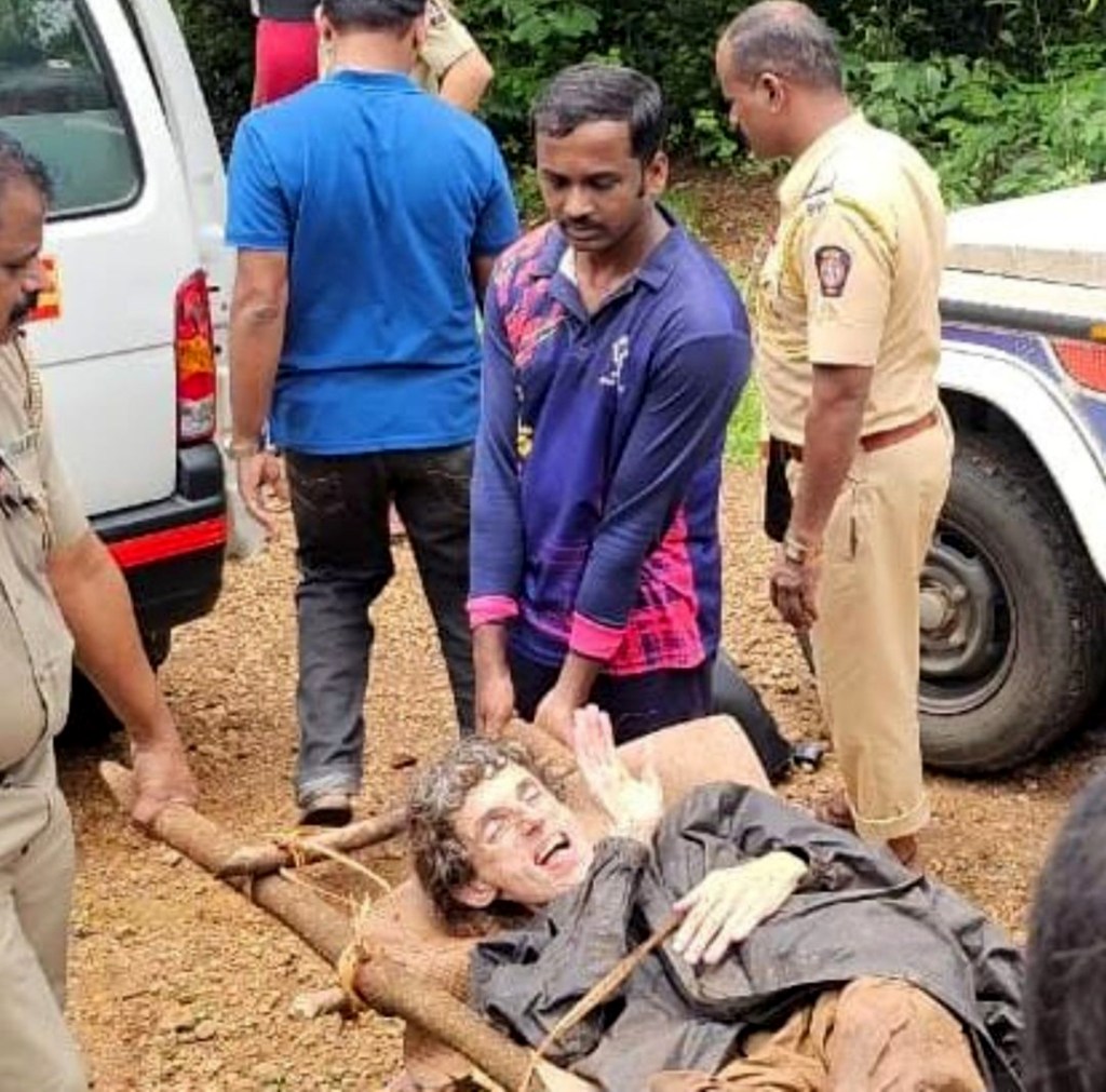 Kumar being carried out of the woods on a stretcher.