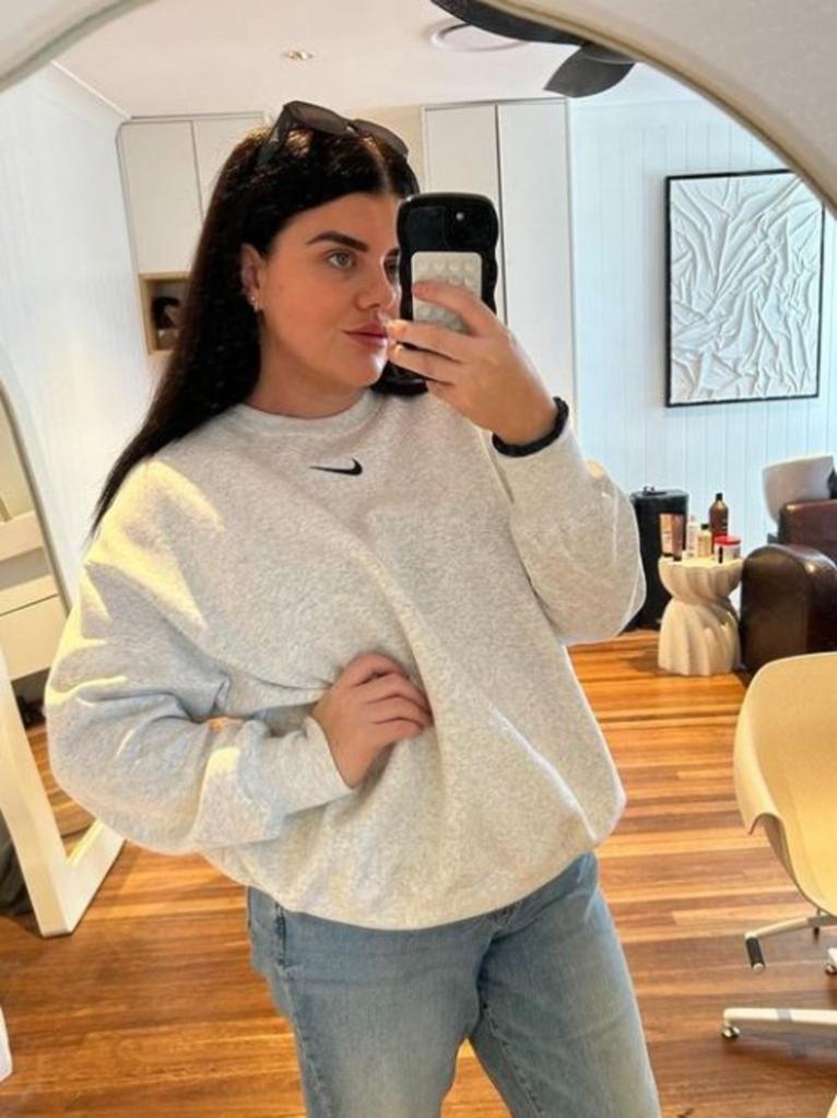 Angela Hutchinson showing off the results of her chin liposuction in a mirror selfie