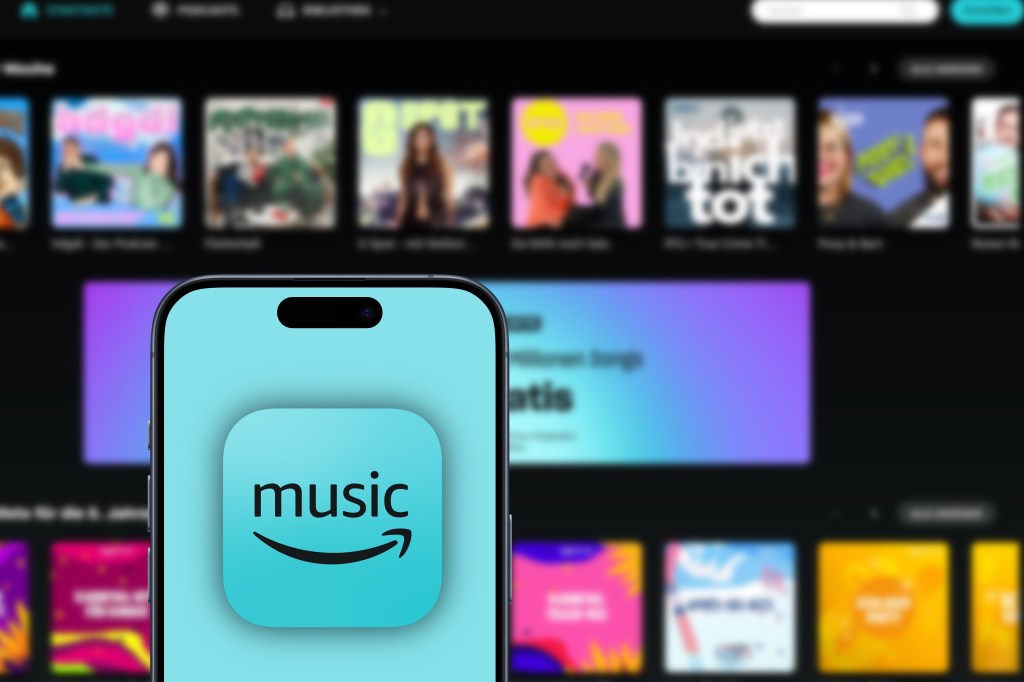 amazon music logo is displayed on an iPhone, website of thenmusic streaming platform and online music store operated by Amazon behind, songs, subscribers