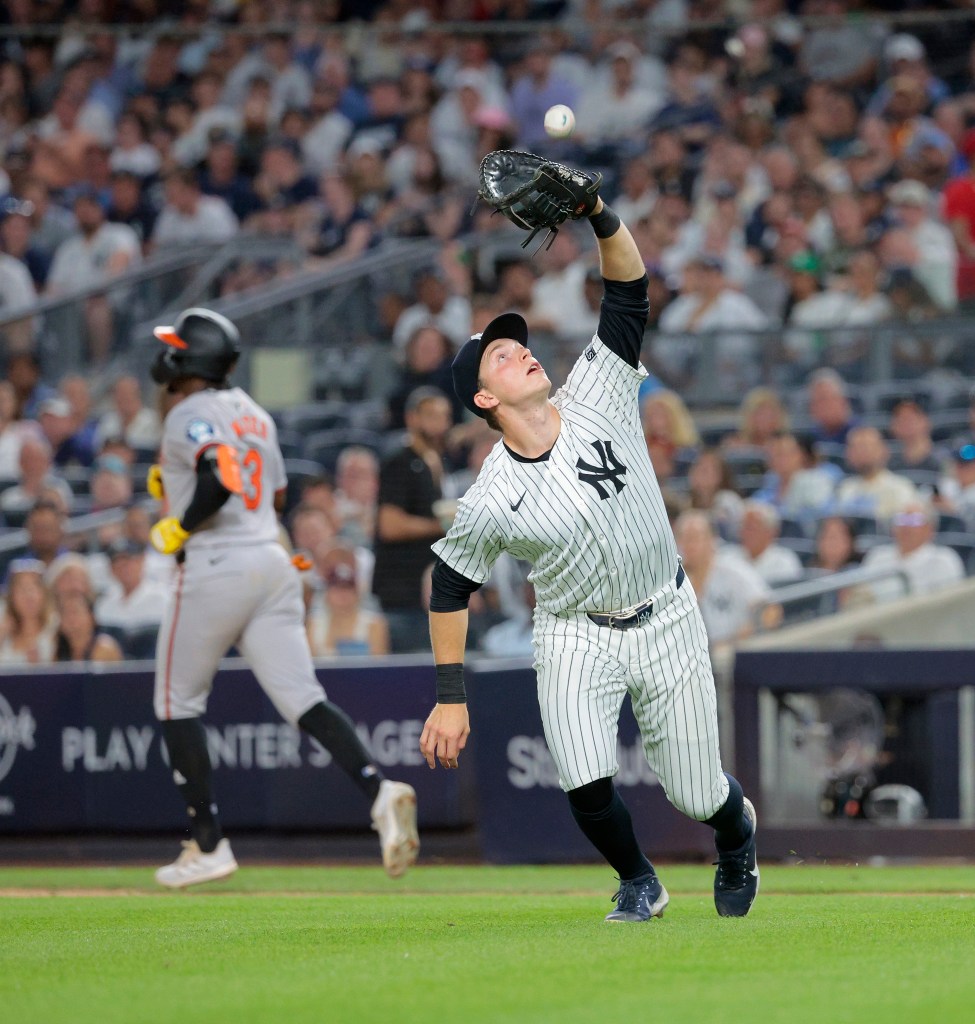 Ben Rice #93 of the New York Yankees catches a pop out hit by Jorge Mateo #3 of the Baltimore Orioles during the 7th inning.