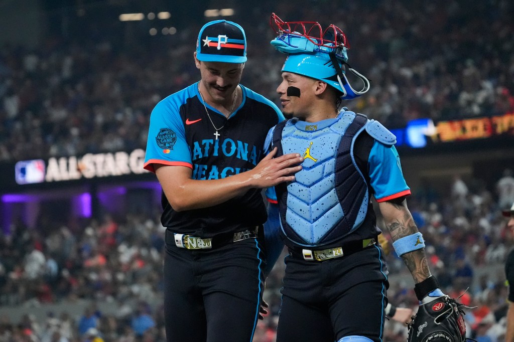 National League's Paul Skenes, left, of the Pittsburgh Pirates, greets William Contreras, of the Milwaukee Brewers, after the first inning of the MLB All-Star baseball game, Tuesday, July 16, 2024, in Arlington, Texas. 