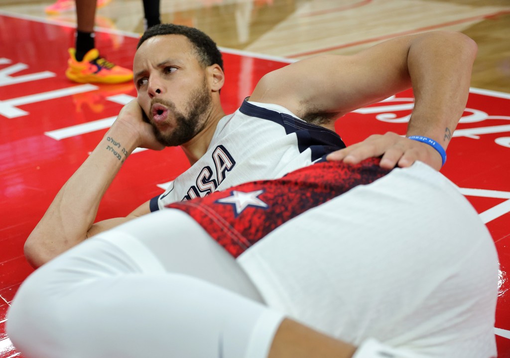 Stephen Curry strikes a pose after getting fouled by Shai Gilgeous-Alexander during the United States' win over Canada.