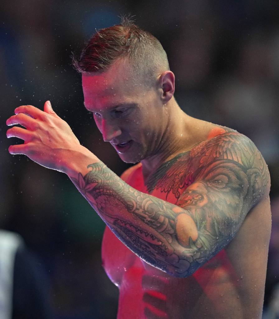 Caeleb Dressel with tattoos on his arm, shaking off water after competing in the 100-meter butterfly final at the U.S. Olympic Team Swimming Trials, Lucas Oil Stadium, Indianapolis, 2024