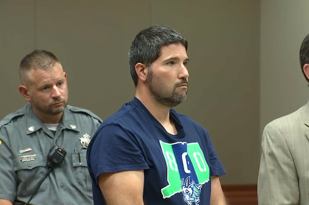 David Laudati, an Arizona swim coach, sitting in front of a microphone after being detained by US Marshals in Connecticut