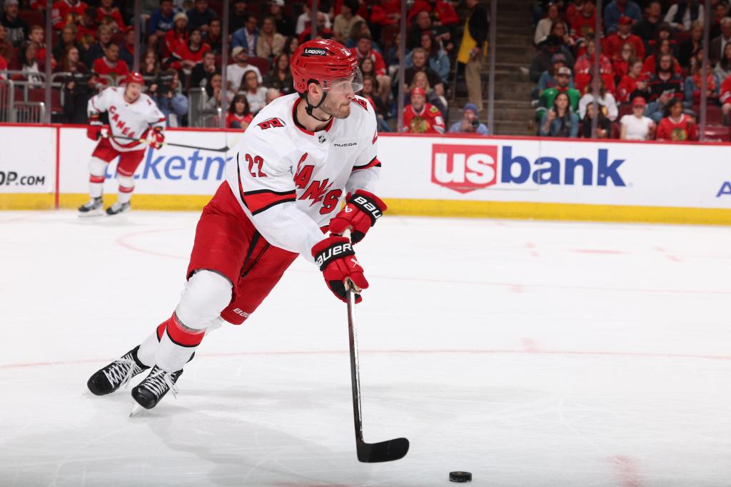 Brett Pesce #22 of the Carolina Hurricanes looks to take the puck up the ice in the second period.