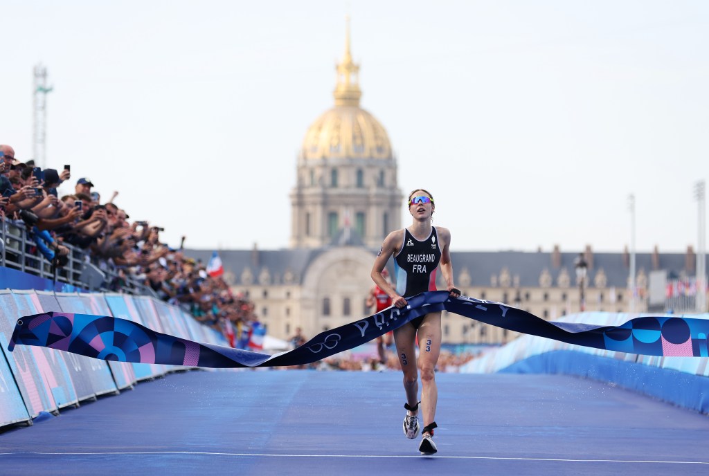 France's Cassandre Beaugrand crosses the finish line to win the gold medal of the women's triathlon on July 31, 2024.