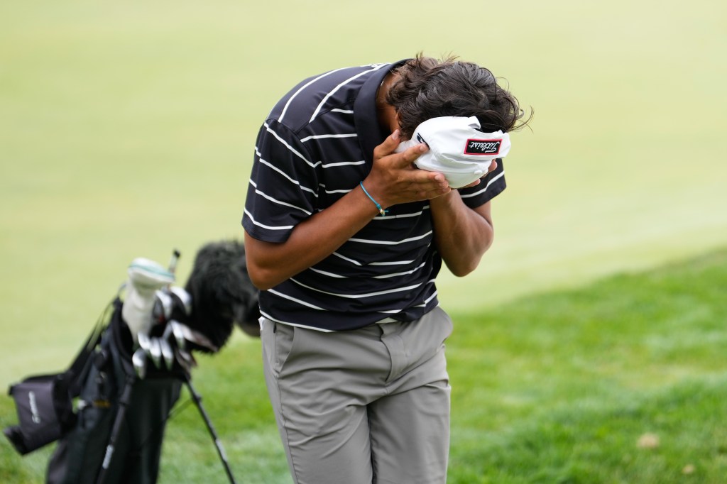 Charlie Woods of the United States reacts after his round on the 18th hole