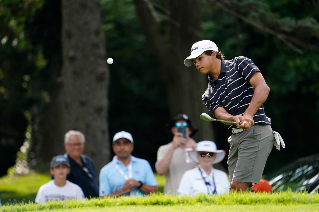 Charlie Woods watches his ball after he hit it out of the rough on hole No. 6 during the 76th U.S. Junior Amateur Championship