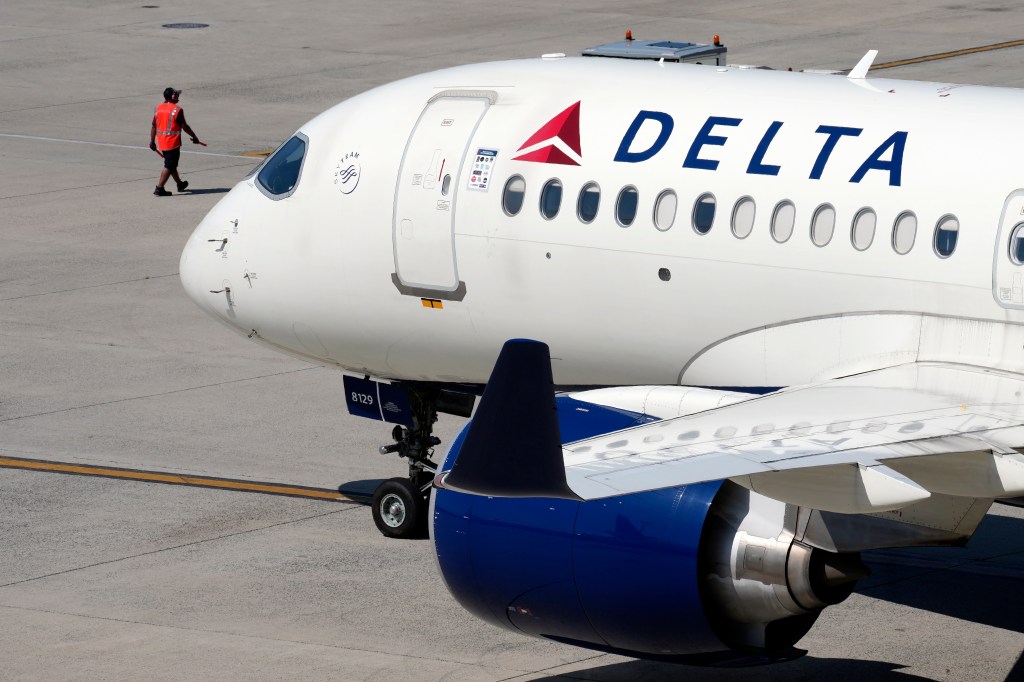 Delta jet leaving the gate at an airport.