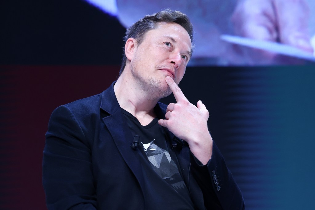 Elon Musk in a suit attending the 'Exploring the New Frontiers of Innovation' session at the Cannes Lions International Festival Of Creativity 2024