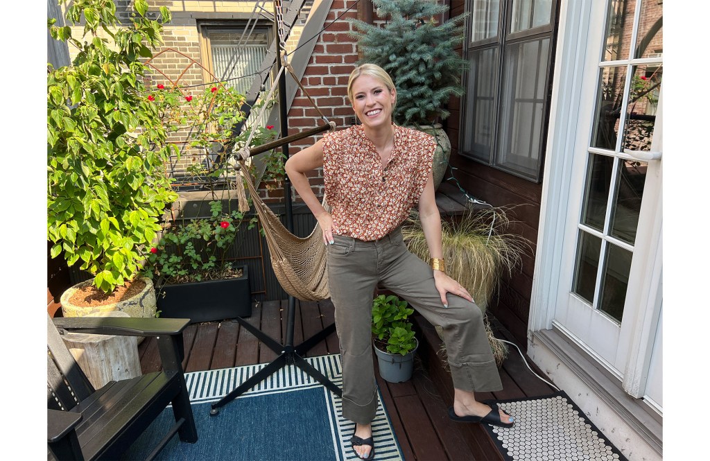 A woman wearing rental clothing on a garden patio. 