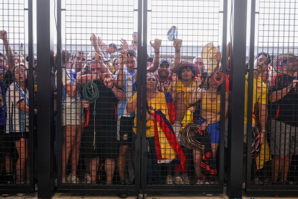 Fans push up against the gates before the Copa America Finals match between Argentina and Colombia at Hard Rock Stadium.