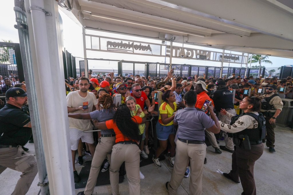 Fans rush the gates before the Copa America Final match between Argentina and Colombia at Hard Rock Stadium.