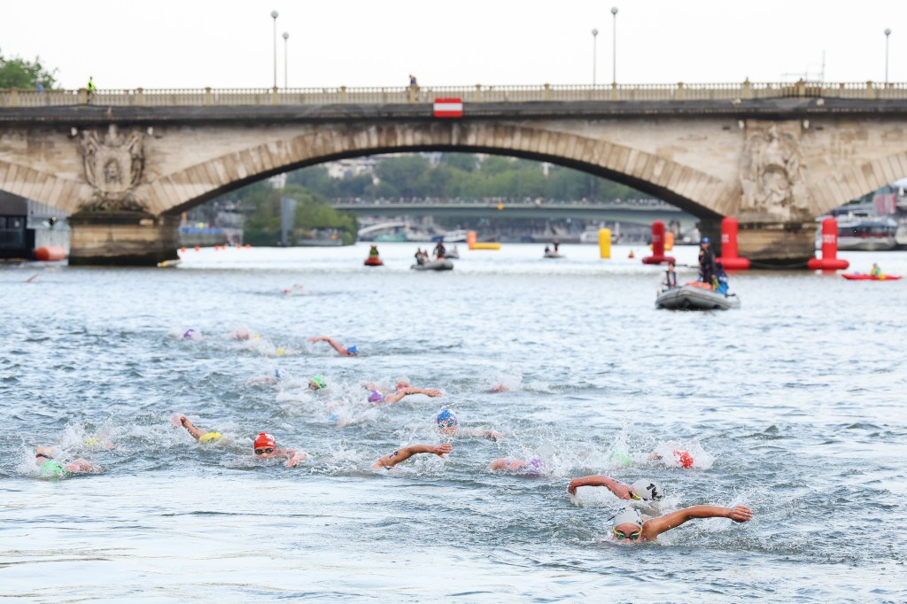 The women began their competition at 8 a.m., just as overnight rain was easing, the triathlon offering spectacular views as they swam in the Seine before racing their bikes and running into central Paris.