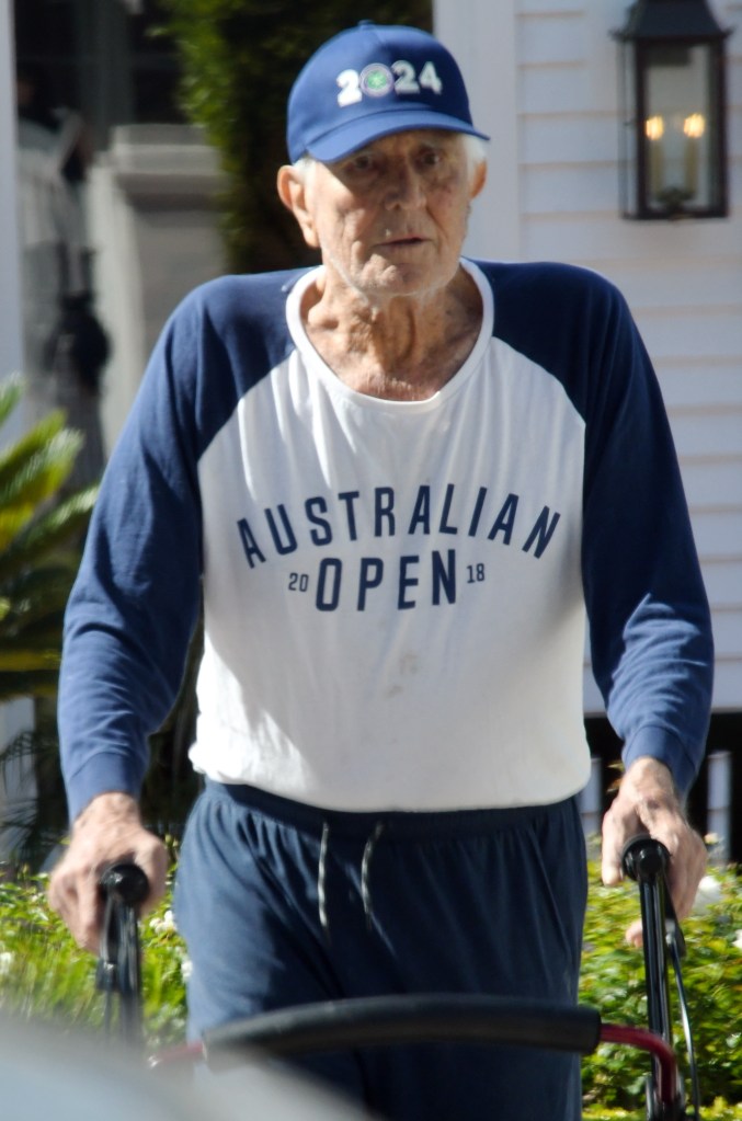 Lazenby wore an Australian Open shirt with sneakers and a baseball cap.