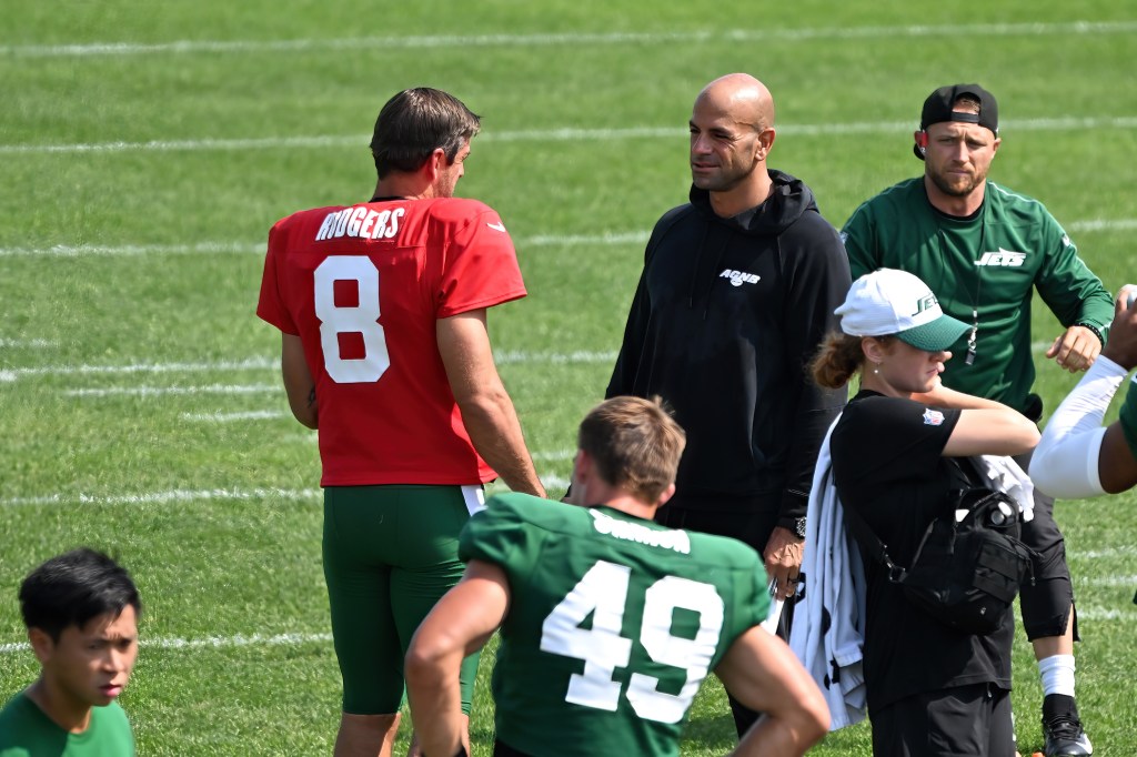 Aaron Rodgers and Robert Saleh speak during practice Monday.