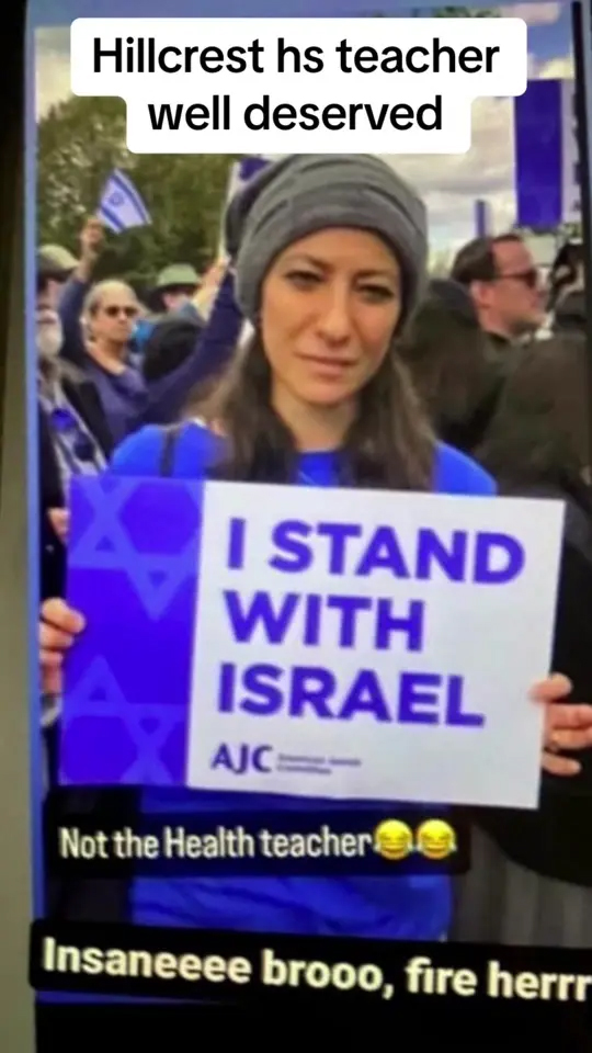 Karen Marder holding a sign and identifying herself as the targeted teacher in antisemitic classroom incident