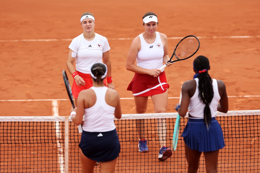 Karolina Muchova and Linda Noskova of Team Czechia being congratulated by Coco Gauff and Jessica Pegula of Team USA after a Women's Doubles Tennis match at the Olympic Games Paris 2024