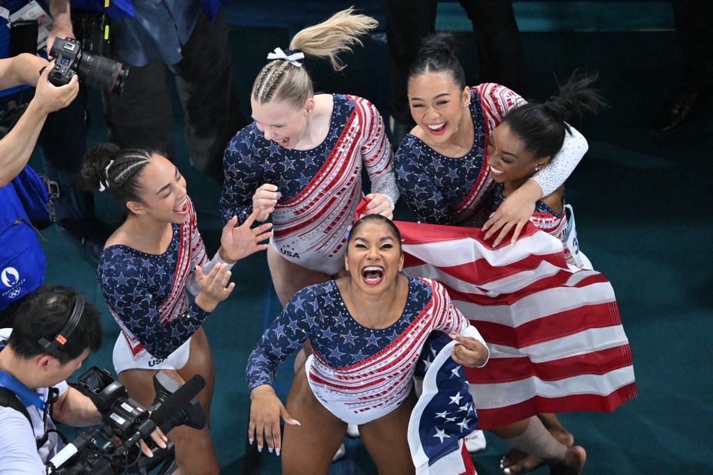 US' Simone Biles (R), US' Sunisa Lee (L), US' Jordan Chiles (front) and US' Jade Carey (back) and US' Hezly Rivera celebrate after winning the artistic gymnastics women's team final during the Paris 2024 Olympic Games at the Bercy Arena in Paris, on July 30, 2024.