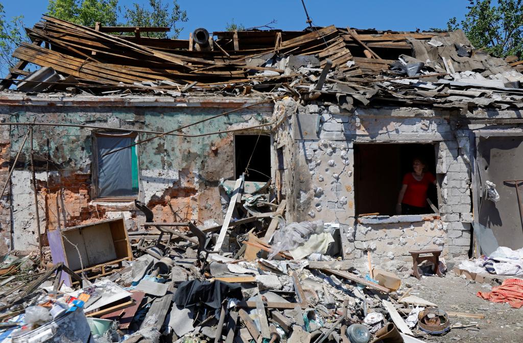 The remnants of a house destroyed by recent Russian shelling show its roof is damaged beyond repair and much of the front of the home has collapsed into rubble.