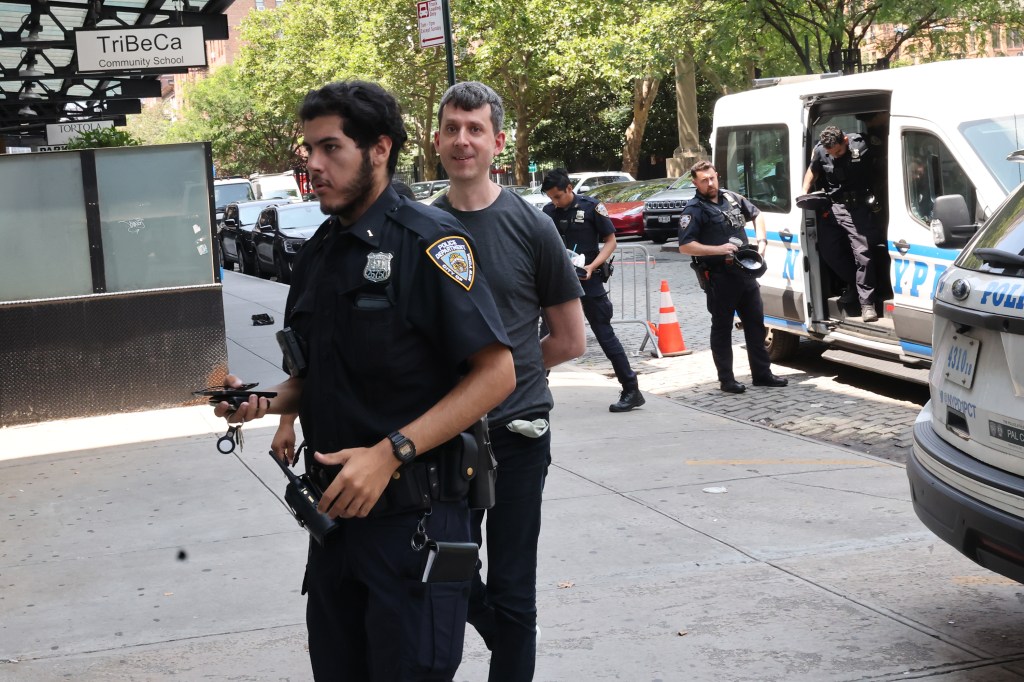 The agitator reportedly ripped a license plate off one of the black SUVs parked on the street during the argument, leading to him being arrested.