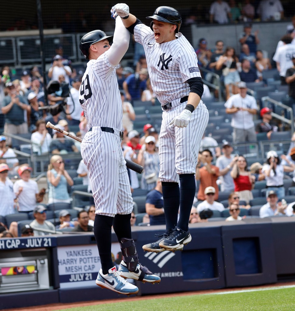 Yankees first baseman Ben Rice #93 celebrates with New York Yankees center fielder Aaron Judge #99 after he scores on his first career home run a solo homer during the 5th inning.