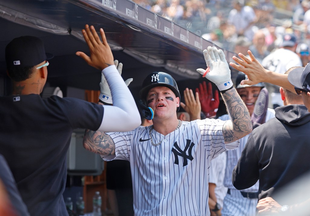 Yankees left fielder Alex Verdugo #24 is greeted by his teammates in the dugout after he scores on his two-run homer during the third inning.