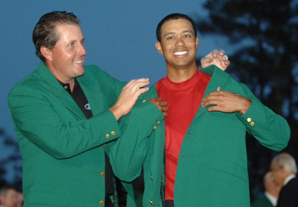 Phil Mickelson puts the Green Jacket on Tiger Woods at the conclusion of the 2005 Masters at Augusta National Golf Club.