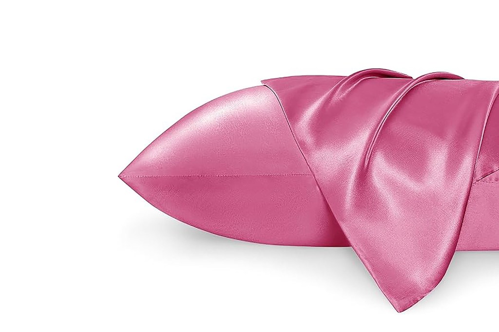 A pink pillow covered with a pink cloth