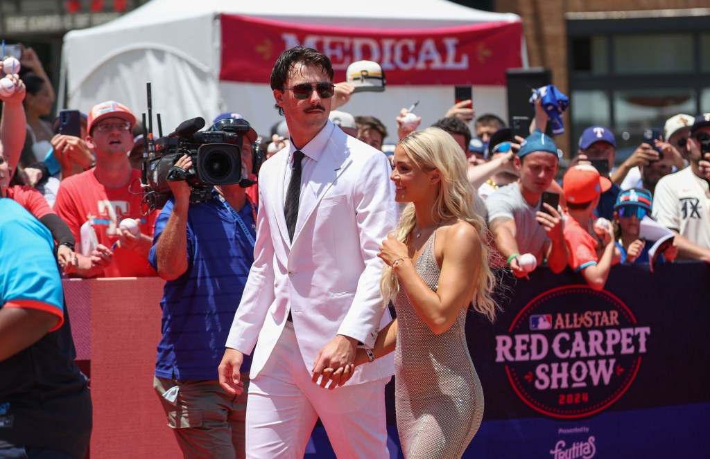 Paul Skenes of the Pittsburgh Pirates walks the red carpet with his girlfriend LSU gymnast Olivia Livvy Dunne before the 2024 MLB All-Star game at Globe Life Field.