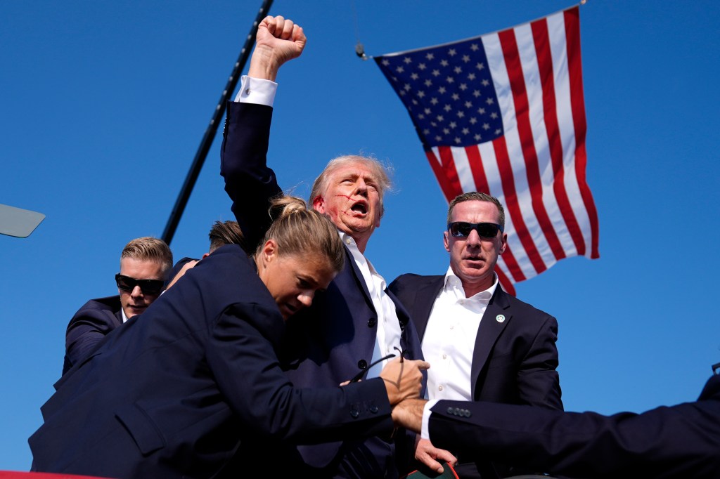 Former President Donald Trump, Republican presidential candidate, surrounded by U.S. Secret Service agents at a campaign rally in Butler, Pennsylvania, 2024