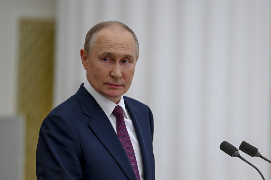 Russian President Vladimir Putin stands in front of microphones during a speech after meeting with Hungarian Prime Minister Viktor Orbán.