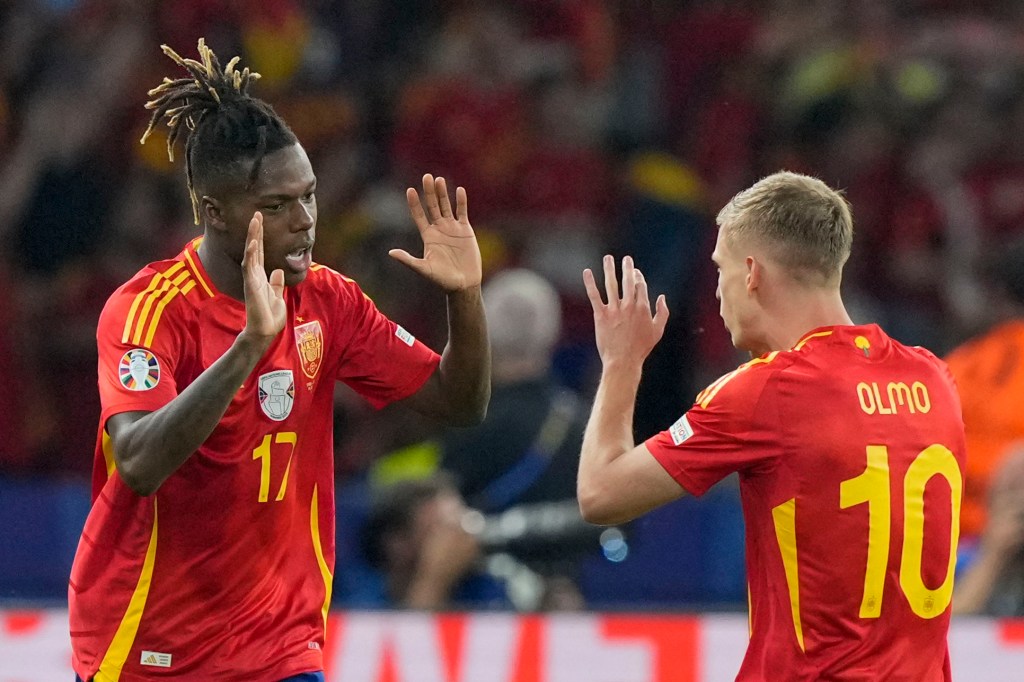 Spain's Nico Williams, left, celebrates with Dani Olmo after scoring the opening goal during the final match against England at the Euro 2024 soccer tournament in Berlin on Sunday.