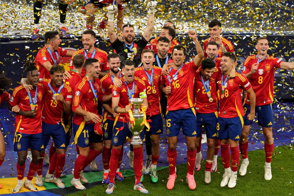 Spain's players celebrate with the trophy after winning the final match between Spain and England  on Sunday.