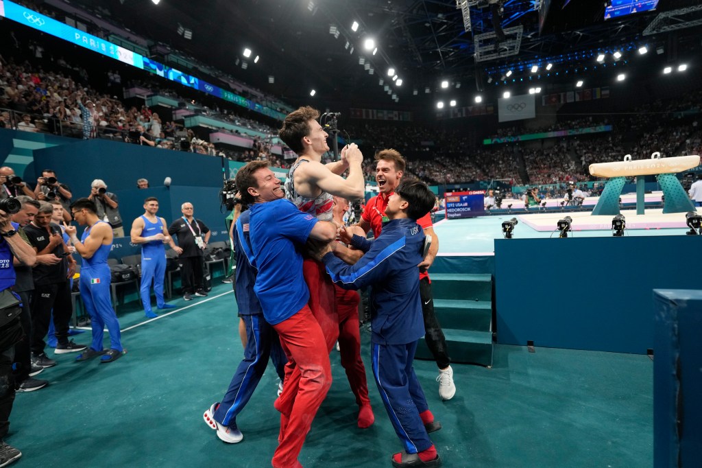 Stephen Nedoroscik, of United States, is lifted by teammates after pommel horse during the men's artistic gymnastics team finals round at Bercy Arena at the 2024 Summer Olympics, Monday, July 29, 2024, in Paris, France. 