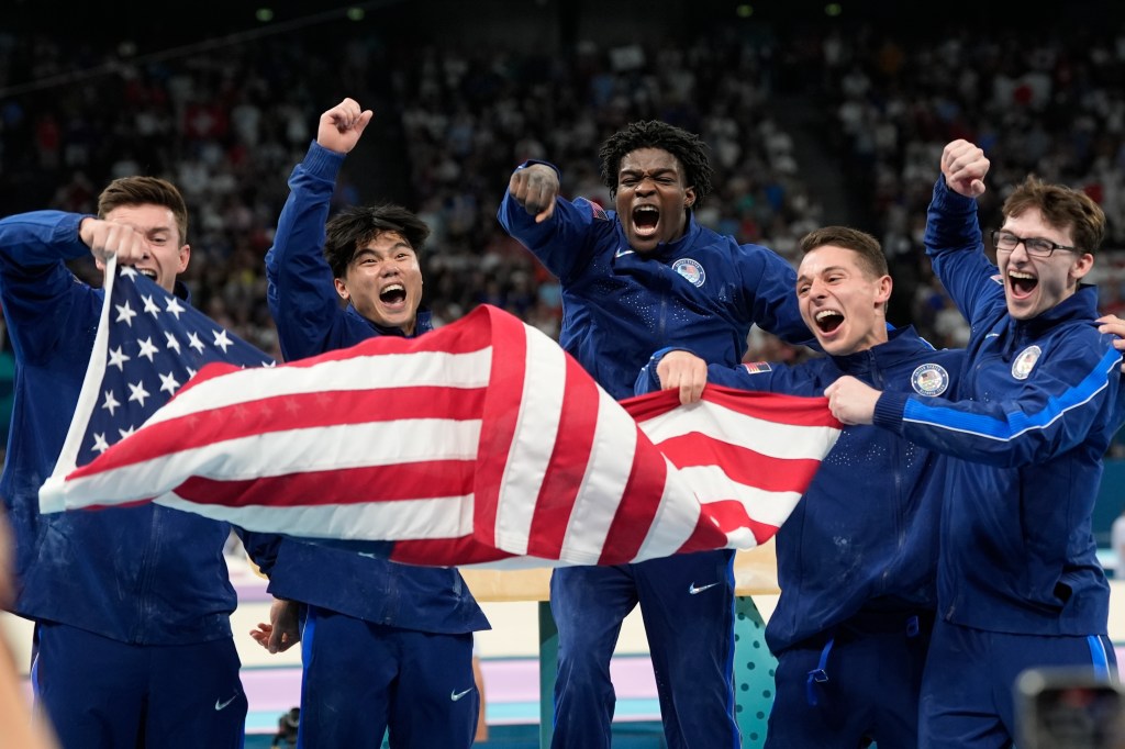 Team USA from left to right Brody Malone, Asher Hong, Fred Richard, Paul Juda and Stephen Nedoroscik, of United States, celebrate their bronze medal during the men's artistic gymnastics team finals round at Bercy Arena at the 2024 Summer Olympics, Monday, July 29, 2024, in Paris, France.