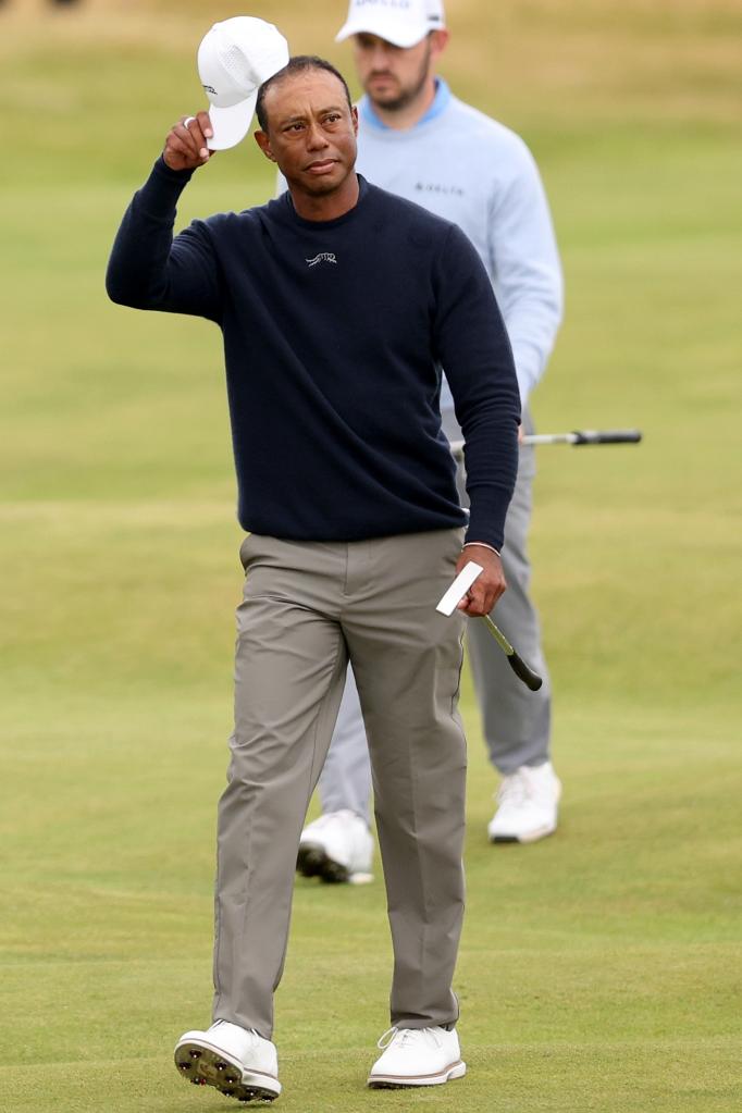 Tiger Woods of the United States acknowledges the crowd as he walks up the 18th fairway during day two of The 152nd Open championship at Royal Troon.