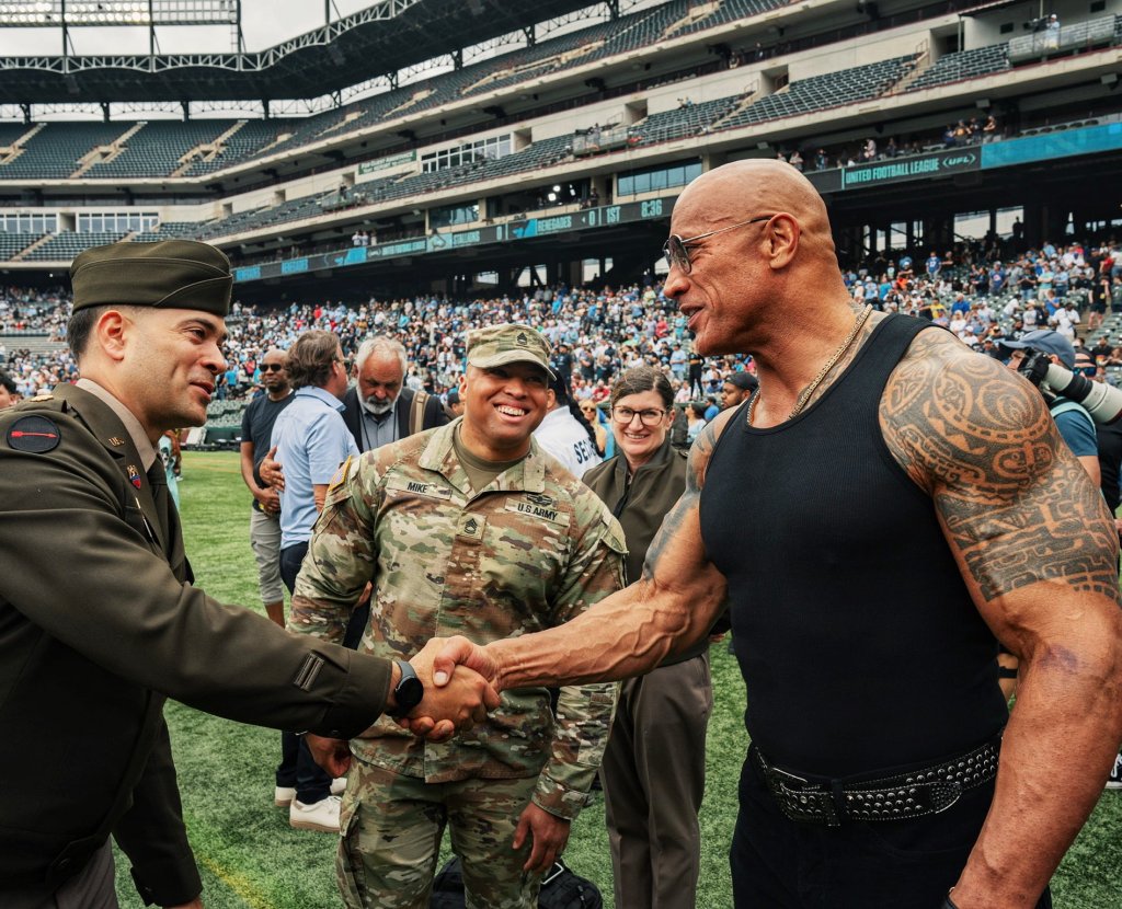 The Rock shaking hands with an Army soldier.