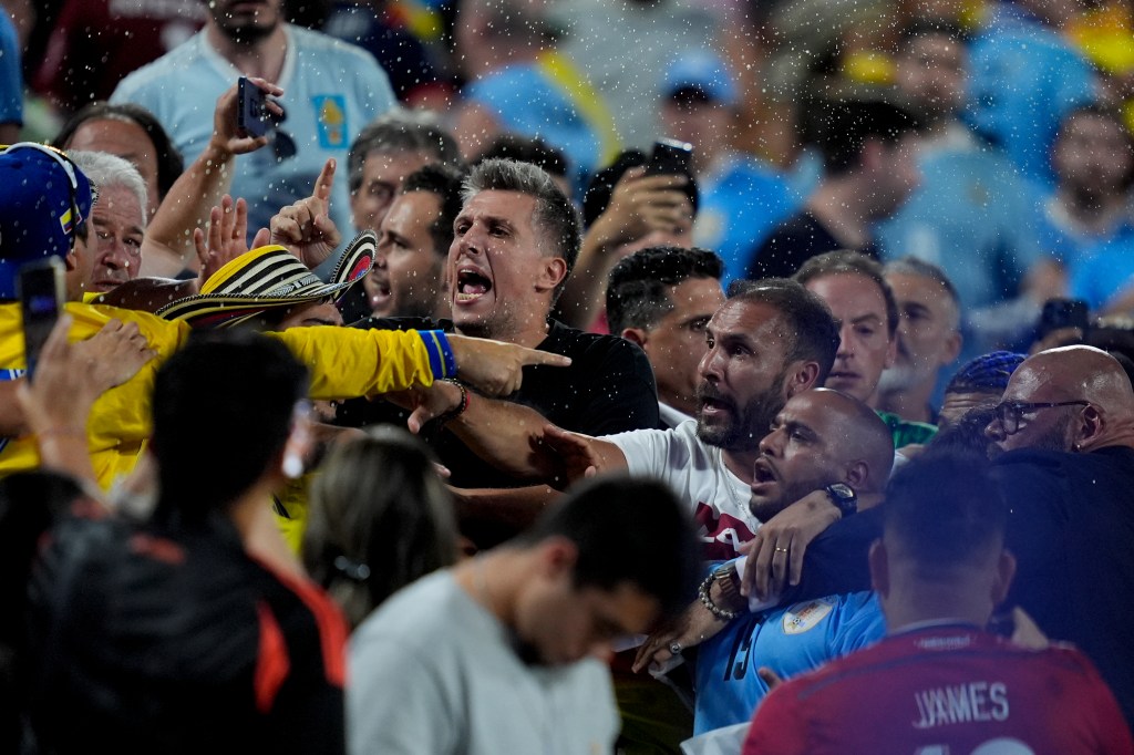 Uruguay's players argue with fans at the end of a Copa America semifinal soccer match