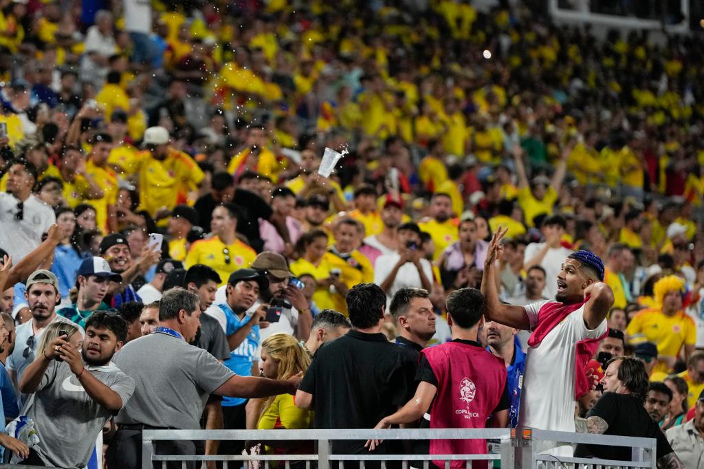 Uruguay's Ronald Araujo, right, argues with fans at the end of a Copa America semifinal soccer match