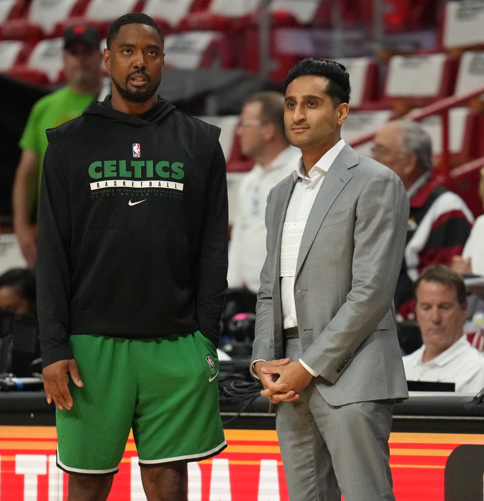 ssistant Coach Aaron Miles of the Boston Celtics and Shams Charania looks on during the game against the Miami Heat during Game 4 of the 2023 NBA Playoffs